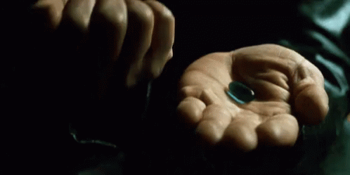 gif com a cena do filme matrix, em que o personagem Morpheus abre as mu00e3os e mostra uma pu00edlula azul e outra pu00edlula vermelha